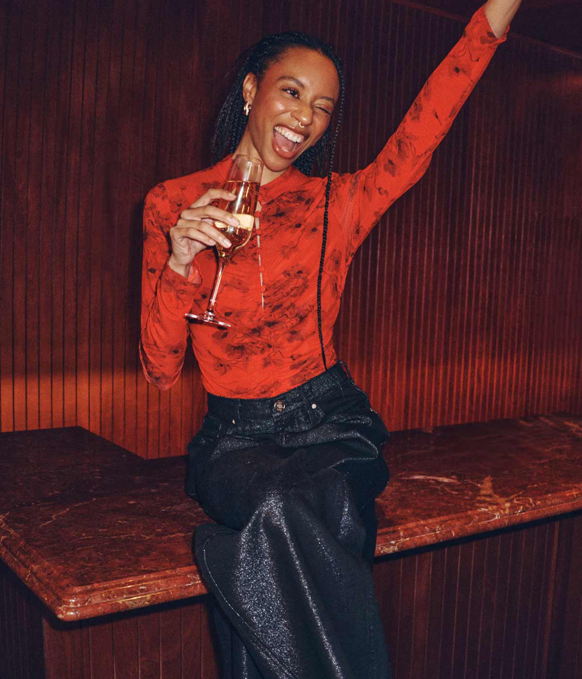 girl winking and holding a drink